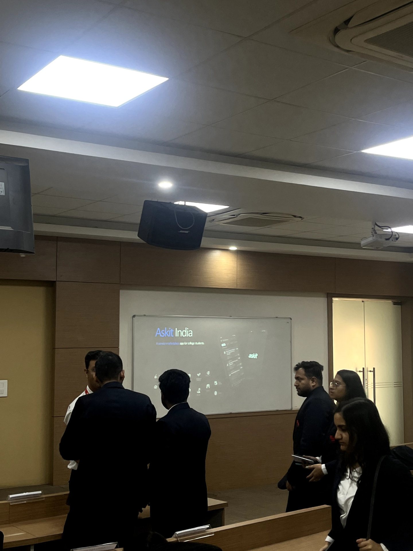 The AskIt India pitch deck on screen during the presentation at SIBM Noida